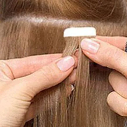 Tape one piece of hair extension under sectioned hair about 1/4 inch from the scalp. and peel the tape cover off